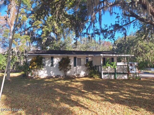 3091 Log Cabin Lane Edgewater, FL 32132 - Photo 1 of 28 a view of a house with backyard and sitting area