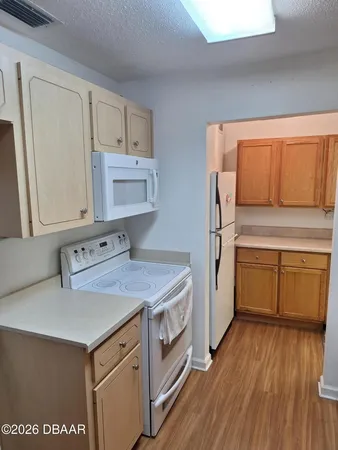 a kitchen with a stove a sink and a refrigerator