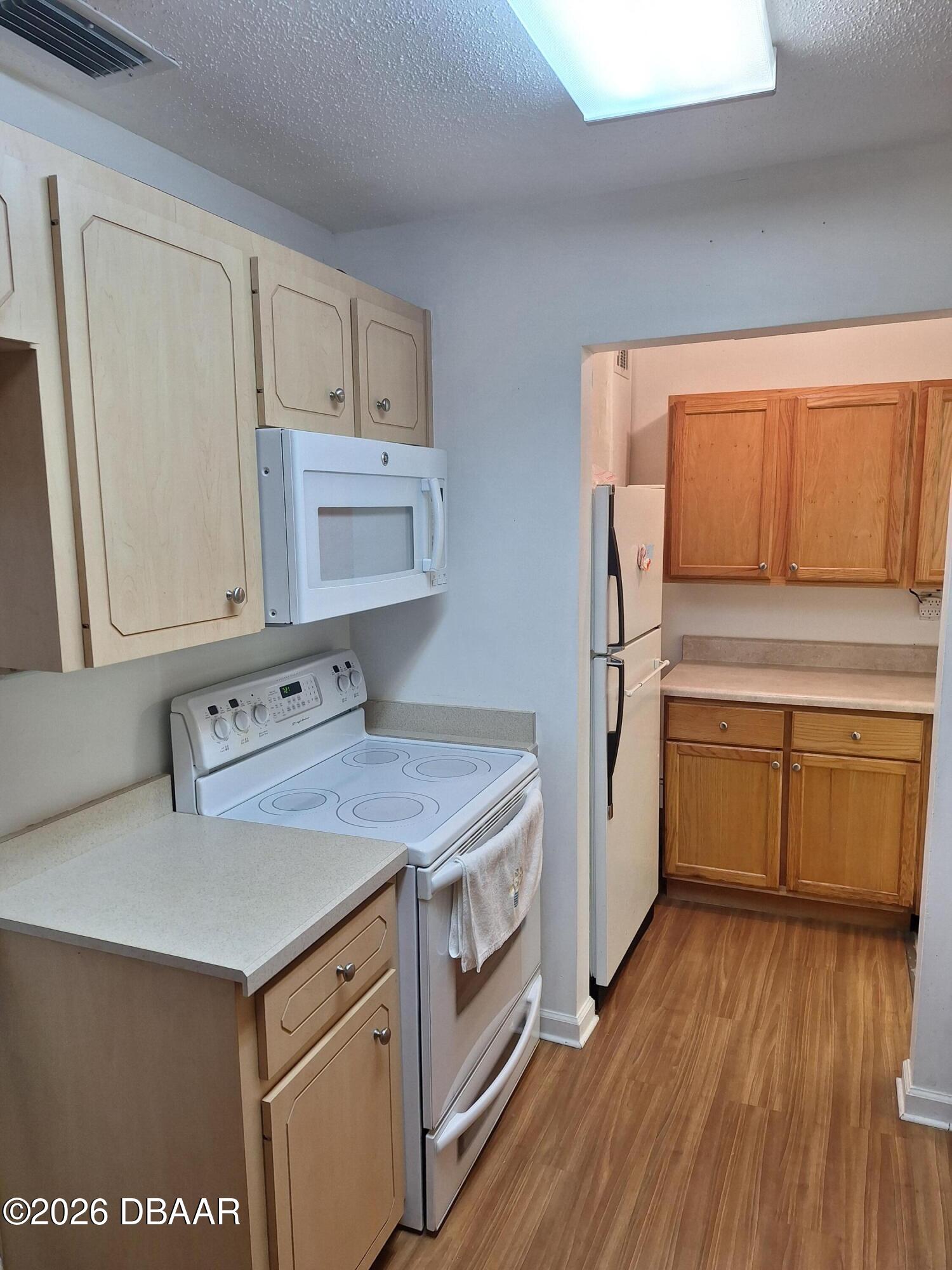 3091 Log Cabin Lane Edgewater, FL 32132 - Photo 17 of 28 a kitchen with a stove a sink and a refrigerator