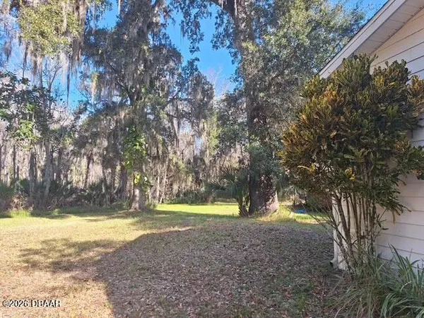 a view of yard with swimming pool and trees