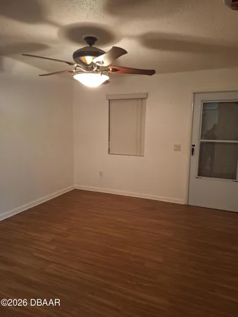 a view of a room with wooden floor