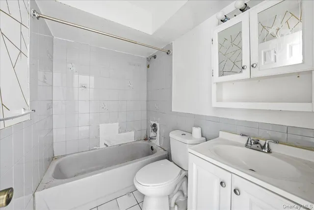 an empty room with closet and natural light