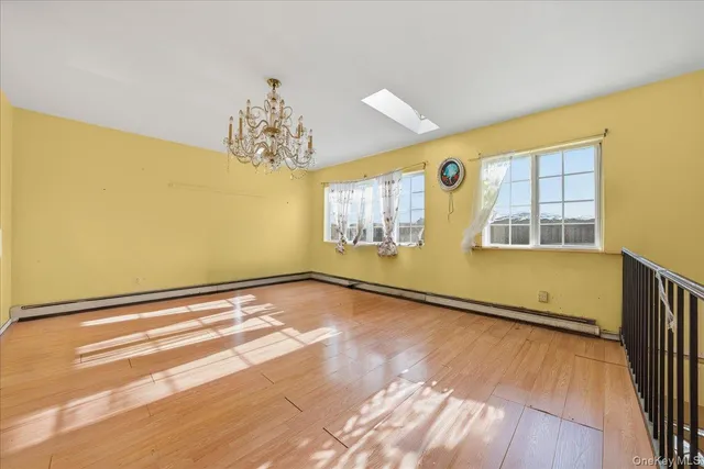a view of a bedroom with wooden floor