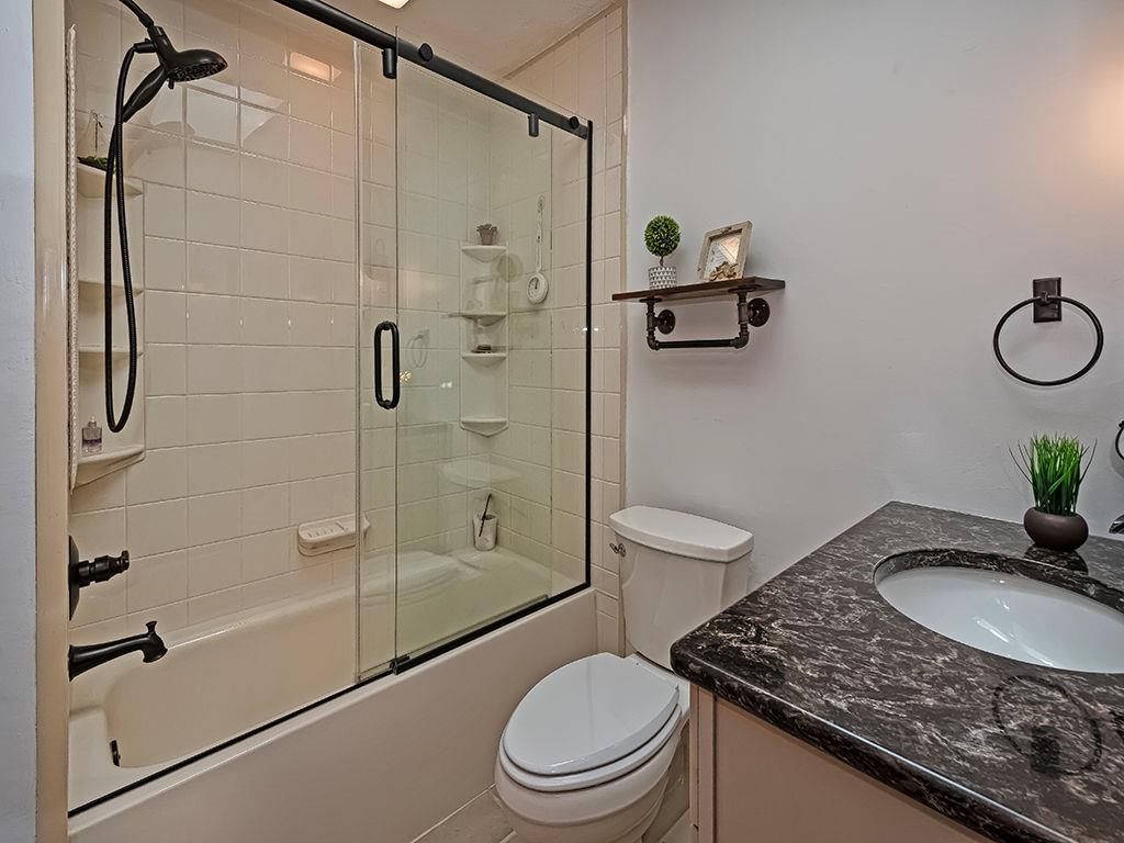 638 Knoll Lane Apollo, PA 15613 - Photo 19 of 30 a bathroom with a granite countertop sink toilet and shower