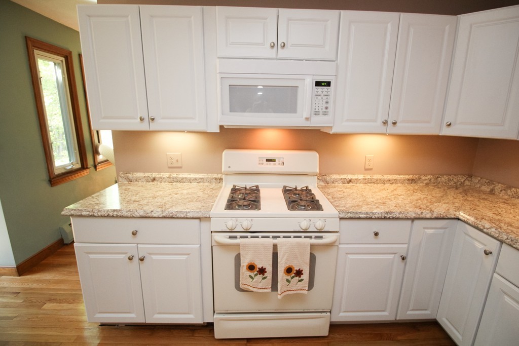 177 Glenwood Road Rutland, MA 01543 - Photo 8 of 30 a kitchen with granite countertop white cabinets and white appliances