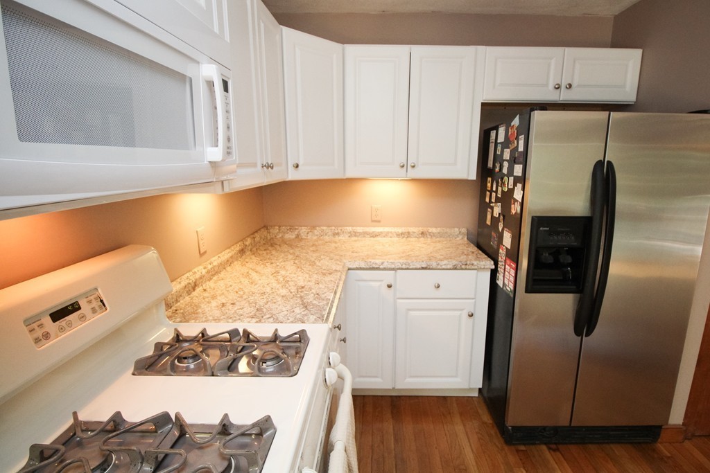 177 Glenwood Road Rutland, MA 01543 - Photo 10 of 30 a kitchen with stainless steel appliances granite countertop a refrigerator and a stove top oven