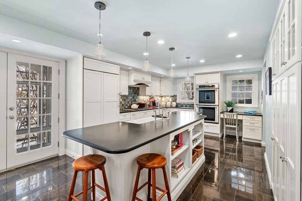 164 Carlton Road Newton, MA 02468 - Photo 4 of 27 a kitchen with stainless steel appliances granite countertop a kitchen island a stove a table and chairs in it