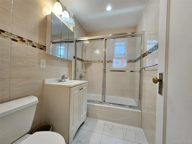 a bathroom with a toilet sink and shower