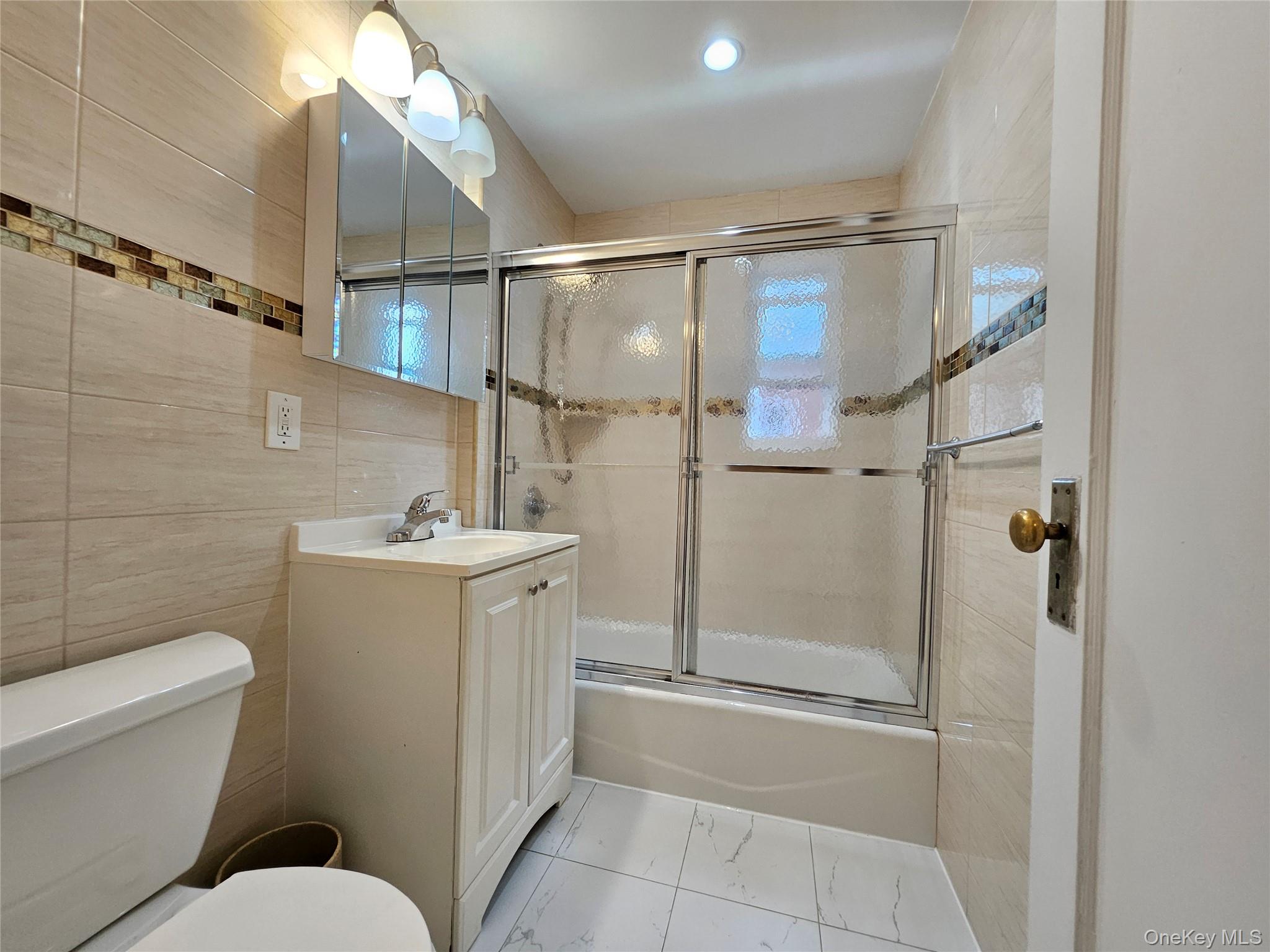 76-40 170th Street, Unit 1 Queens, NY 11366 - Photo 11 of 17 a bathroom with a toilet sink and shower