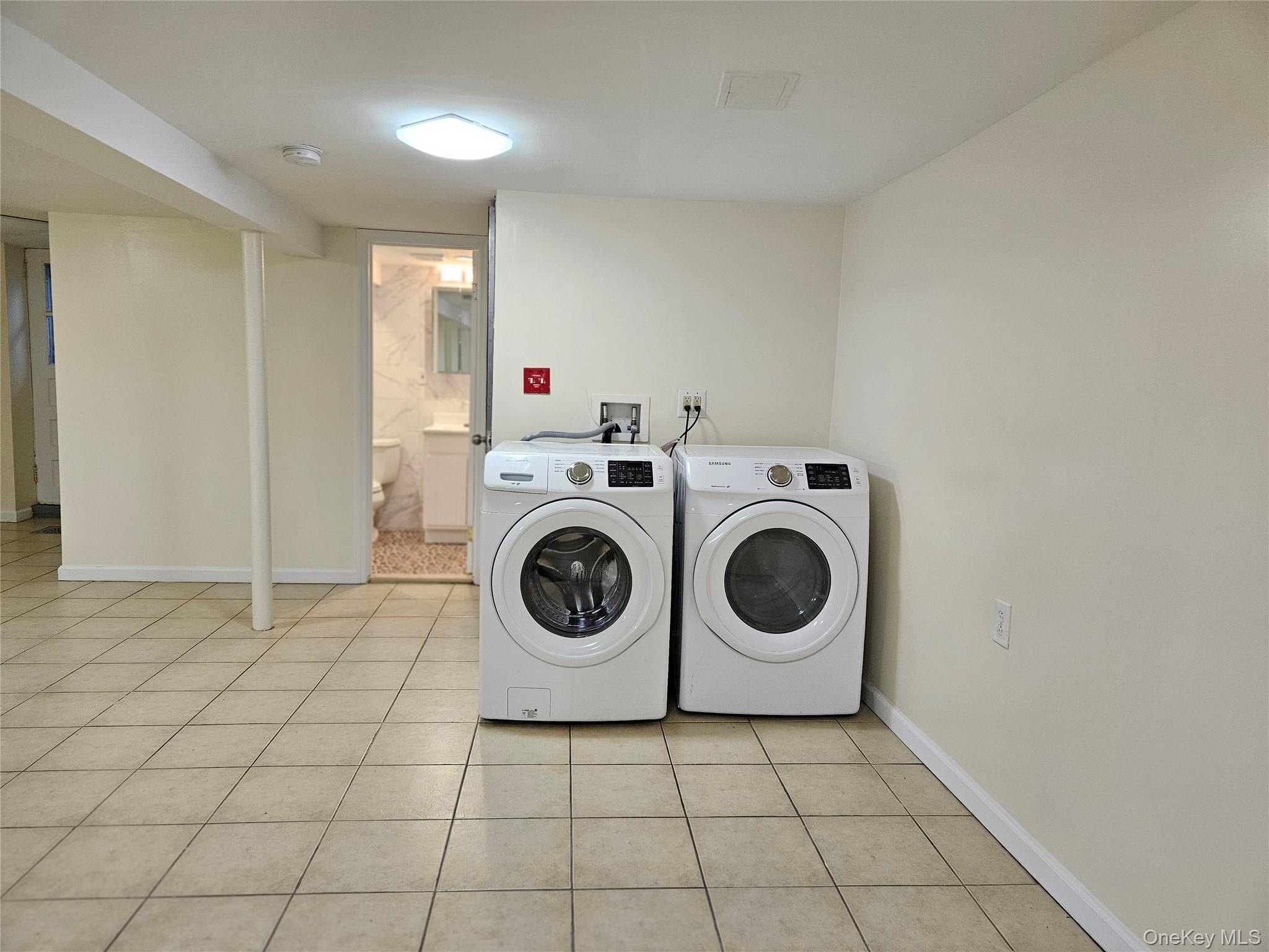 76-40 170th Street, Unit 1 Queens, NY 11366 - Photo 13 of 17 a utility room with dryer and washer