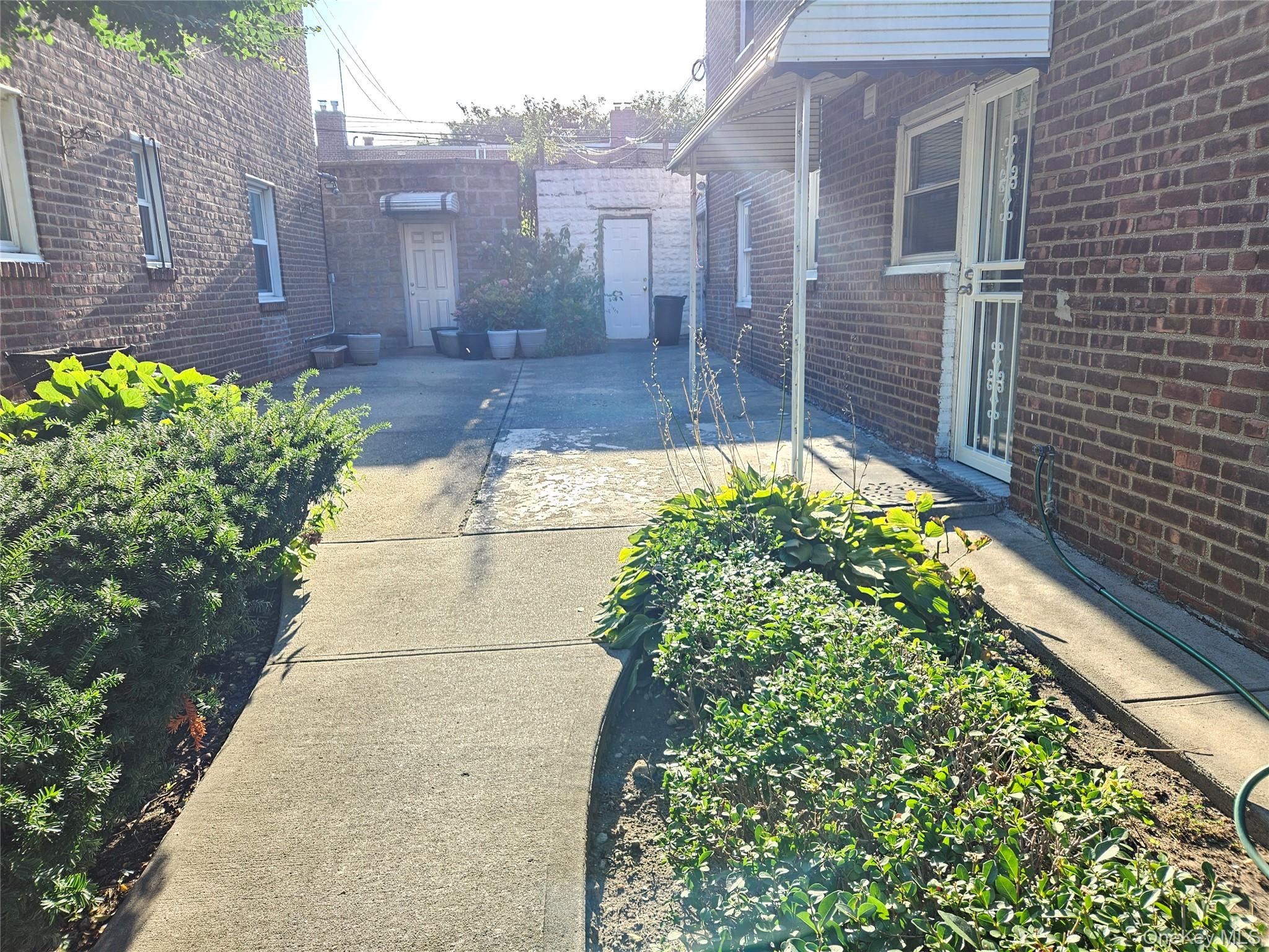 76-40 170th Street, Unit 1 Queens, NY 11366 - Photo 15 of 17 a view of a pathway with a house