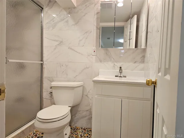 a bathroom with a sink toilet and mirror