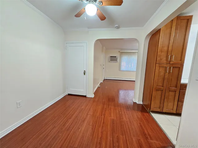 a view of a room with wooden floor and staircase