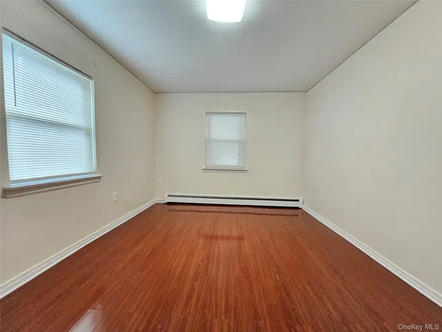 a view of a room with wooden floors and window