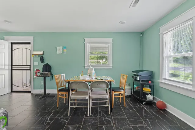 a dining room with furniture and wooden floor