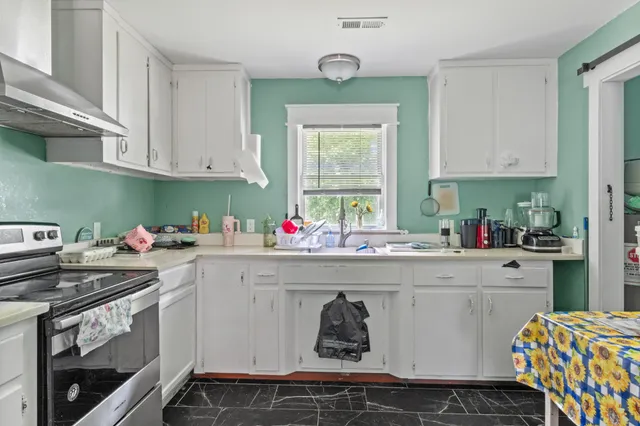 a bedroom with furniture and wooden floor