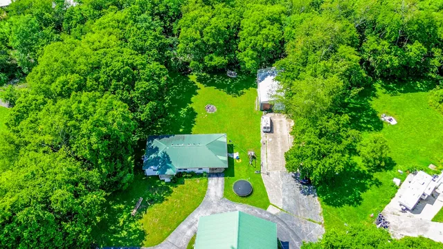 an aerial view of a house with garden space and street view