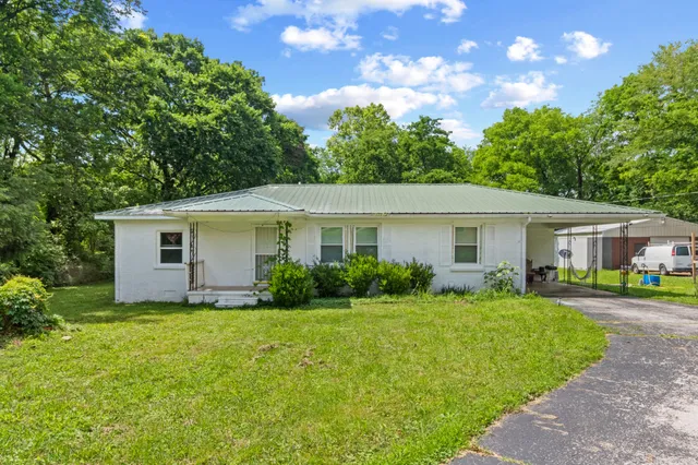 a view of a house with a yard and garden
