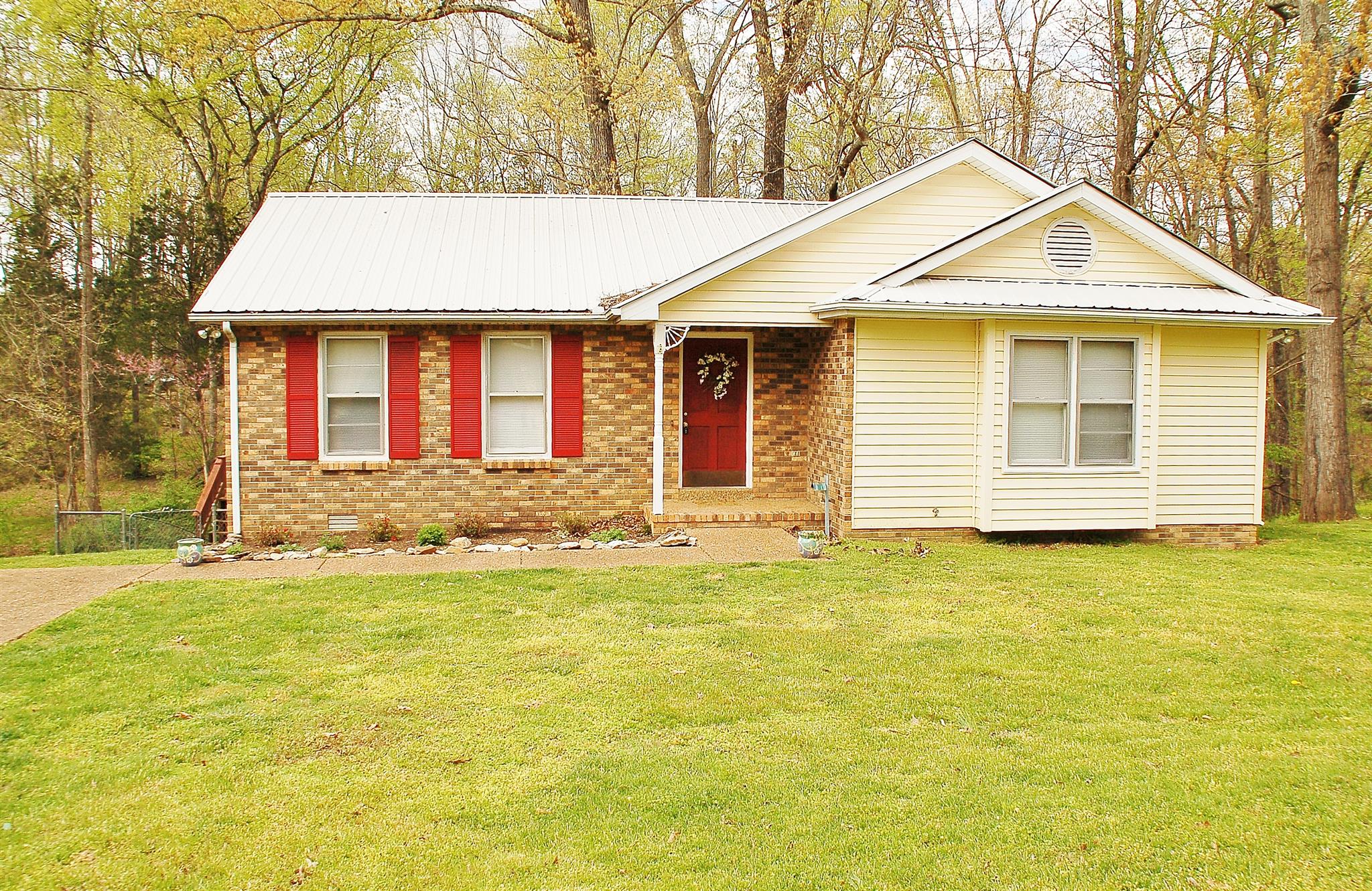 7112 Totty Road Fairview, TN 37062 - Photo 1 of 14 a front view of a house with a yard and garage