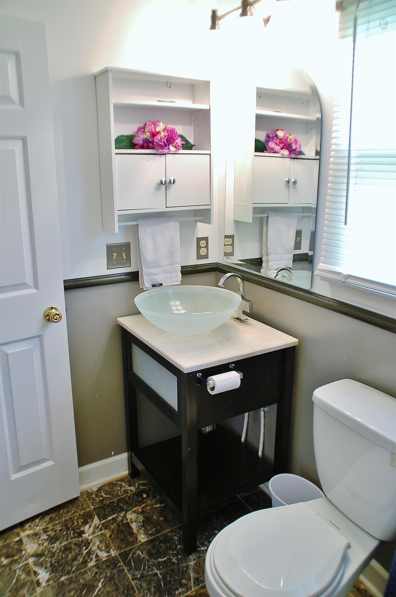 7112 Totty Road Fairview, TN 37062 - Photo 13 of 14 a kitchen with a sink cabinets and wooden floor