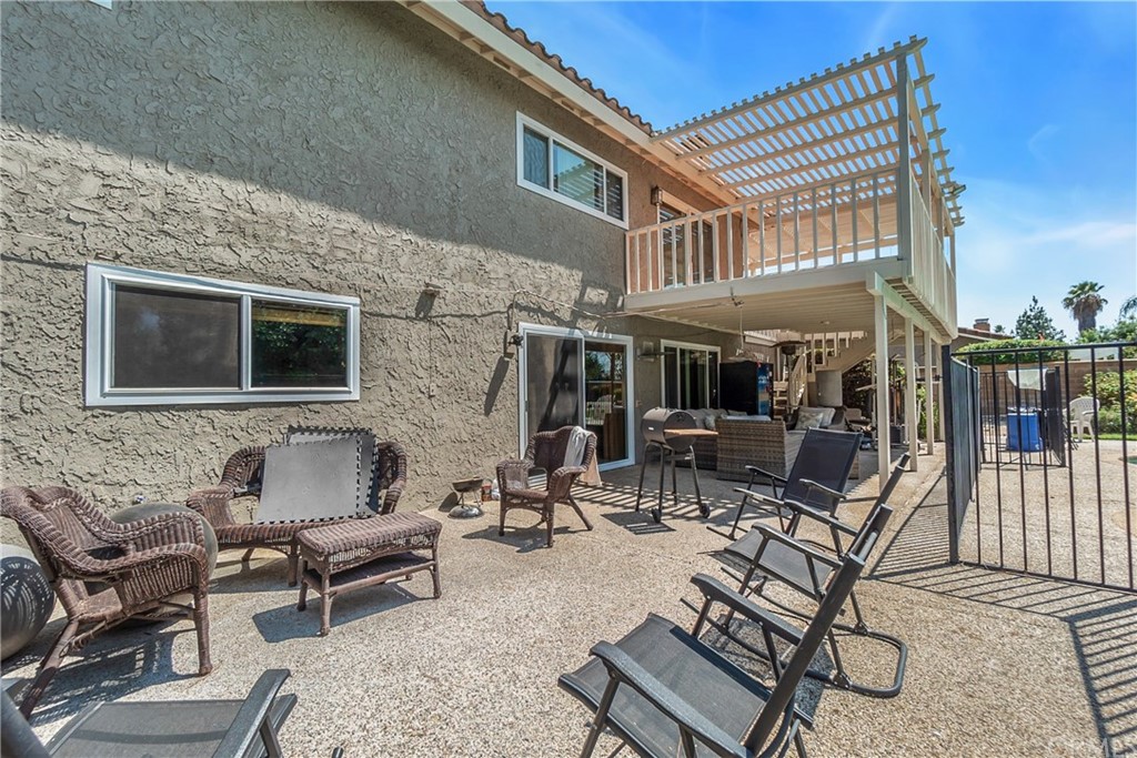 6717 Rycroft Drive Riverside, CA 92506 - Photo 21 of 28 a view of a patio with couches table and chairs with wooden floor
