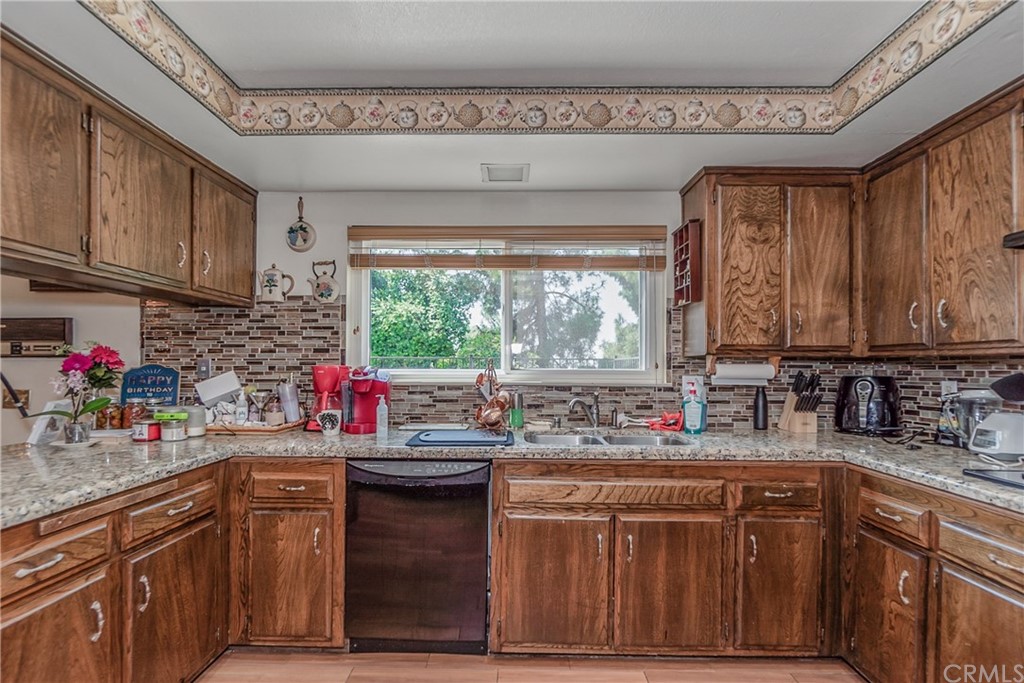 6717 Rycroft Drive Riverside, CA 92506 - Photo 8 of 28 a kitchen with a sink cabinets and window