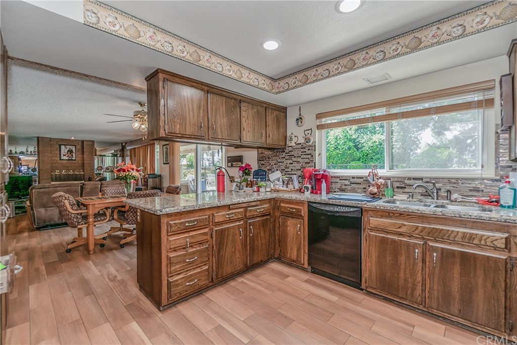 6717 Rycroft Drive Riverside, CA 92506 - Photo 9 of 28 a kitchen with lots of counter top space and wooden floor