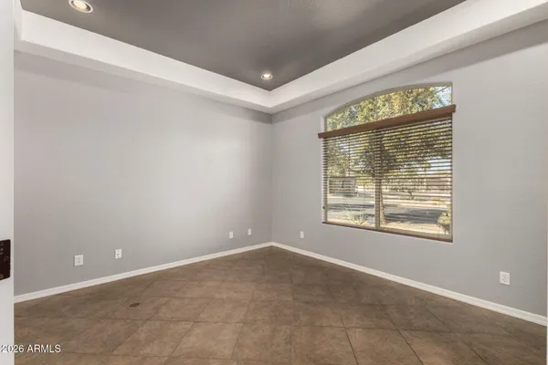 a view of an empty room with a fireplace and a window