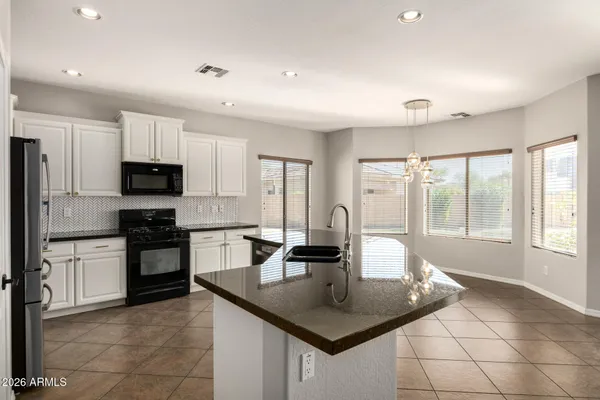 a kitchen with granite countertop a sink and cabinets