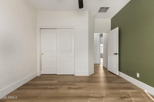 a view of empty room with wooden floor