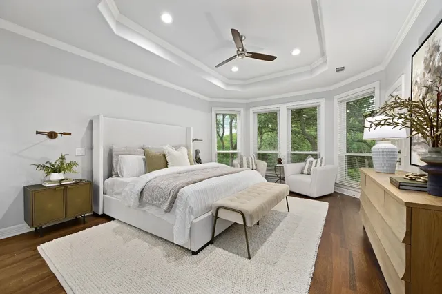 a bedroom with a large bed and a chandelier