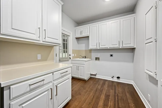 a kitchen with white cabinets and white appliances