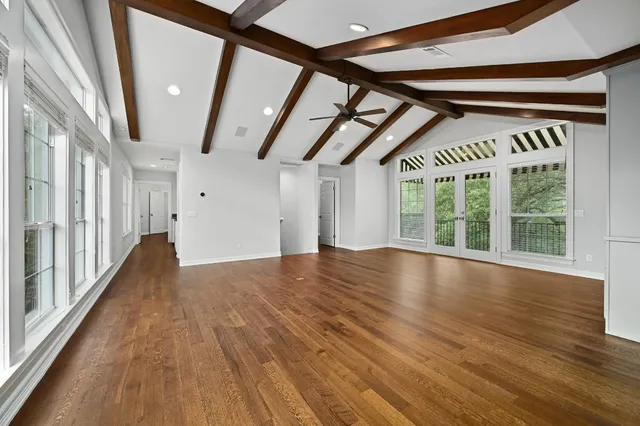 a view of room with wooden floor and furniture