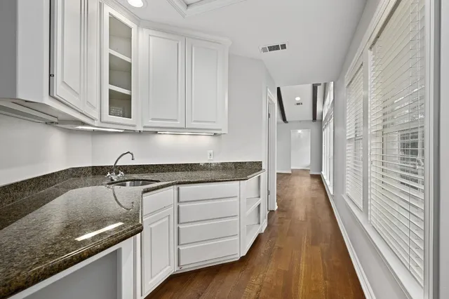a kitchen with granite countertop a sink and stove