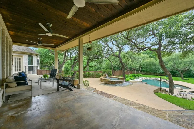 a view of swimming pool with outdoor seating and a porch