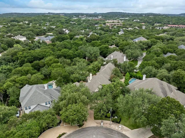 an aerial view of a house with yard
