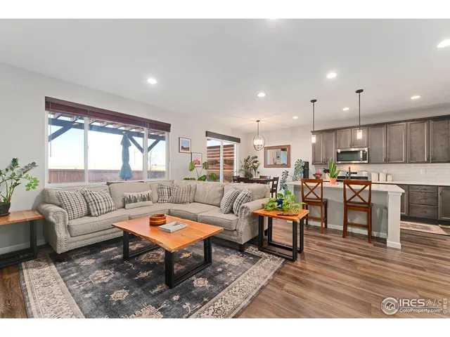 a living room with furniture kitchen and a table