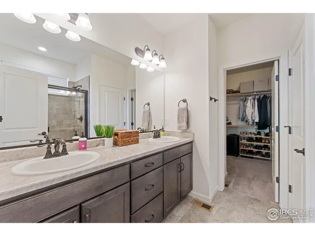 a bathroom with a sink double vanity and a mirror