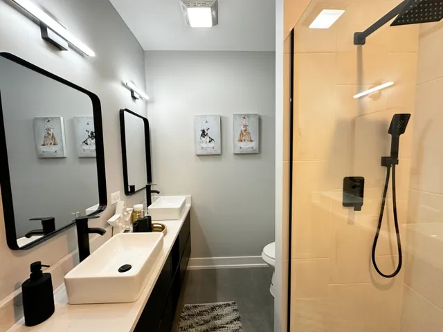 a bathroom with a tub sink and mirror
