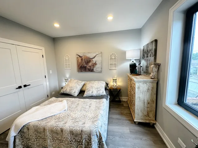 a bedroom with a bed and a flat tv screen