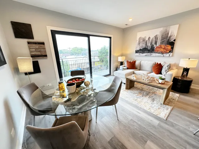 a living room with furniture and a floor to ceiling window