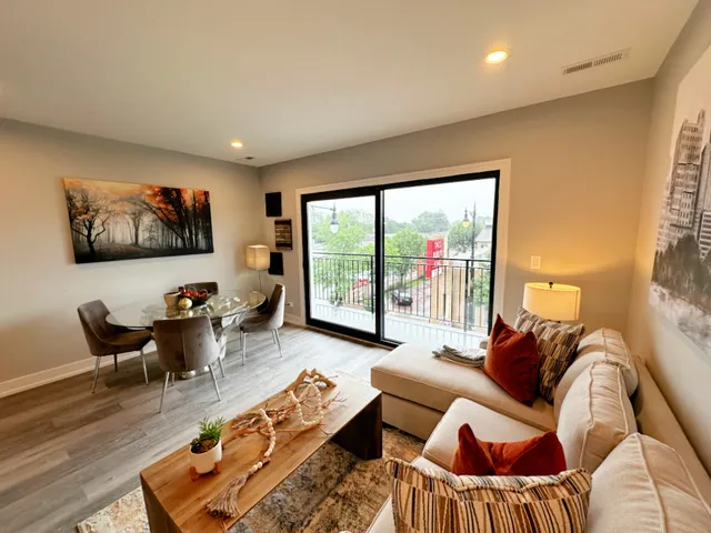 a living room with furniture large window and a flat screen tv