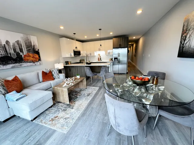 a living room with furniture and kitchen view