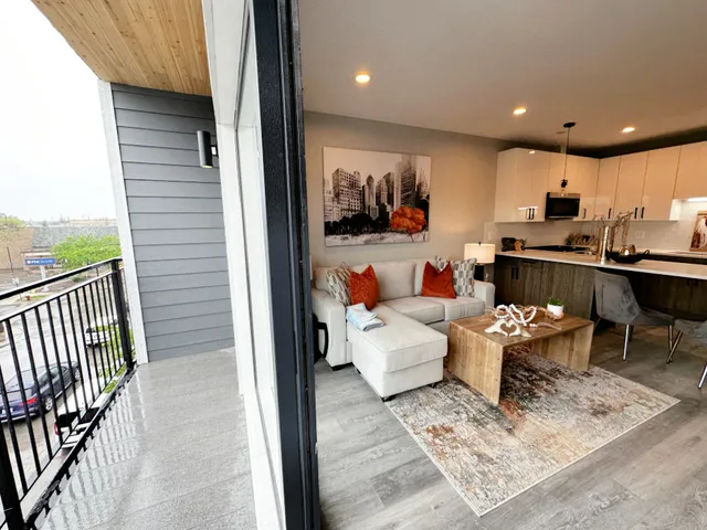 a living room with a couch and a potted plant