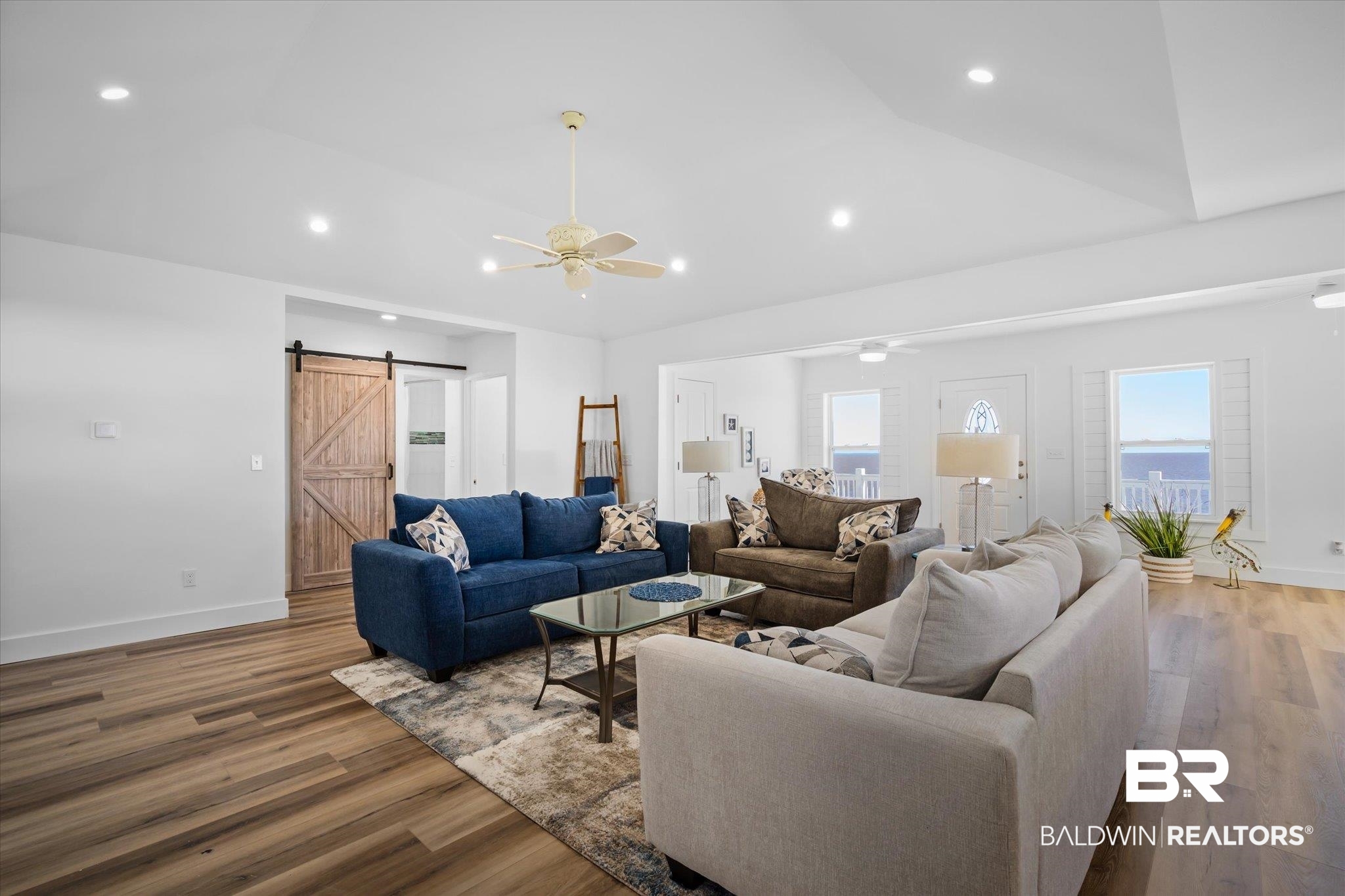 15111 Regus Road Coden, AL 36523 - Photo 8 of 35 Living area featuring a barn door, a ceiling fan, recessed lighting, and wood finished floors