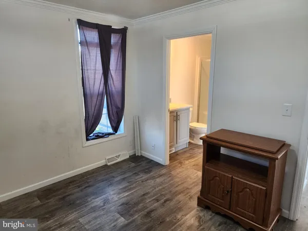 a view of an empty room and wooden floor
