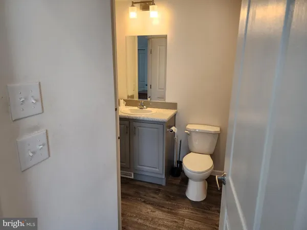 a view of a small space with wooden floor and a window