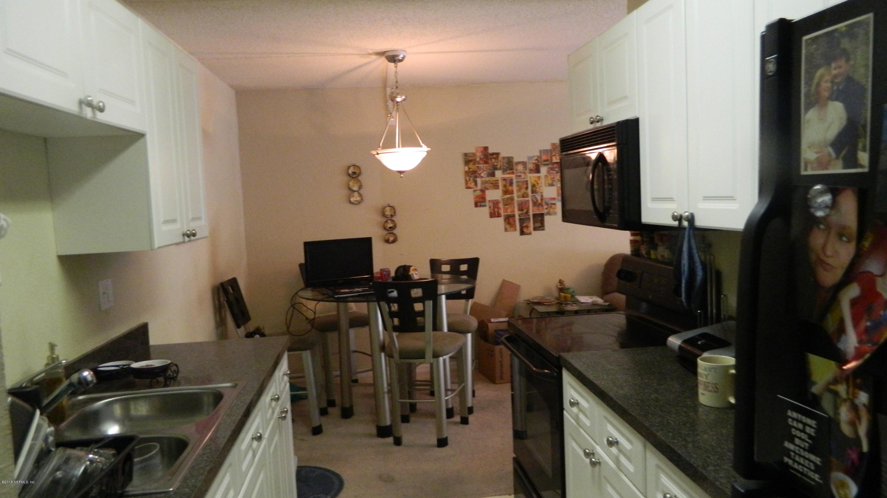 355 Monument Road, Unit 22D2 Jacksonville, FL 32225 - Photo 4 of 14 a kitchen with a sink appliances and cabinets