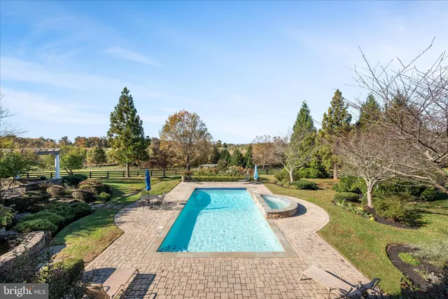 a front view of a house with plants and trees