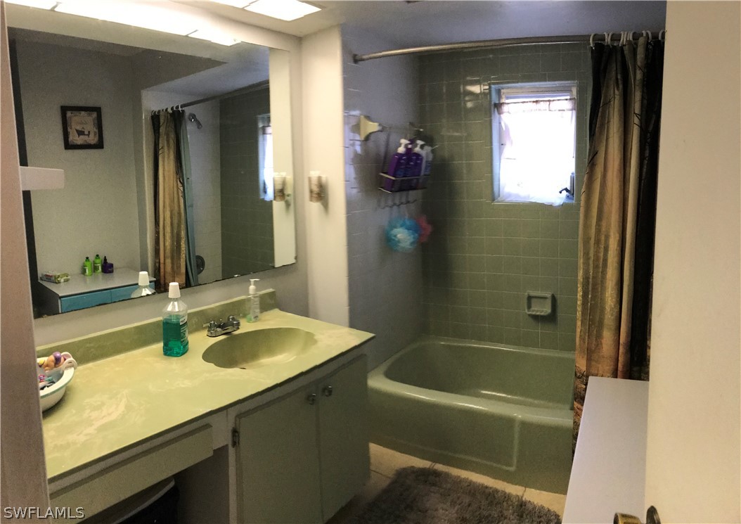 7312 Pebble Beach Road Fort Myers, FL 33967 - Photo 14 of 30 a bathroom with a sink tub vanity and a mirror